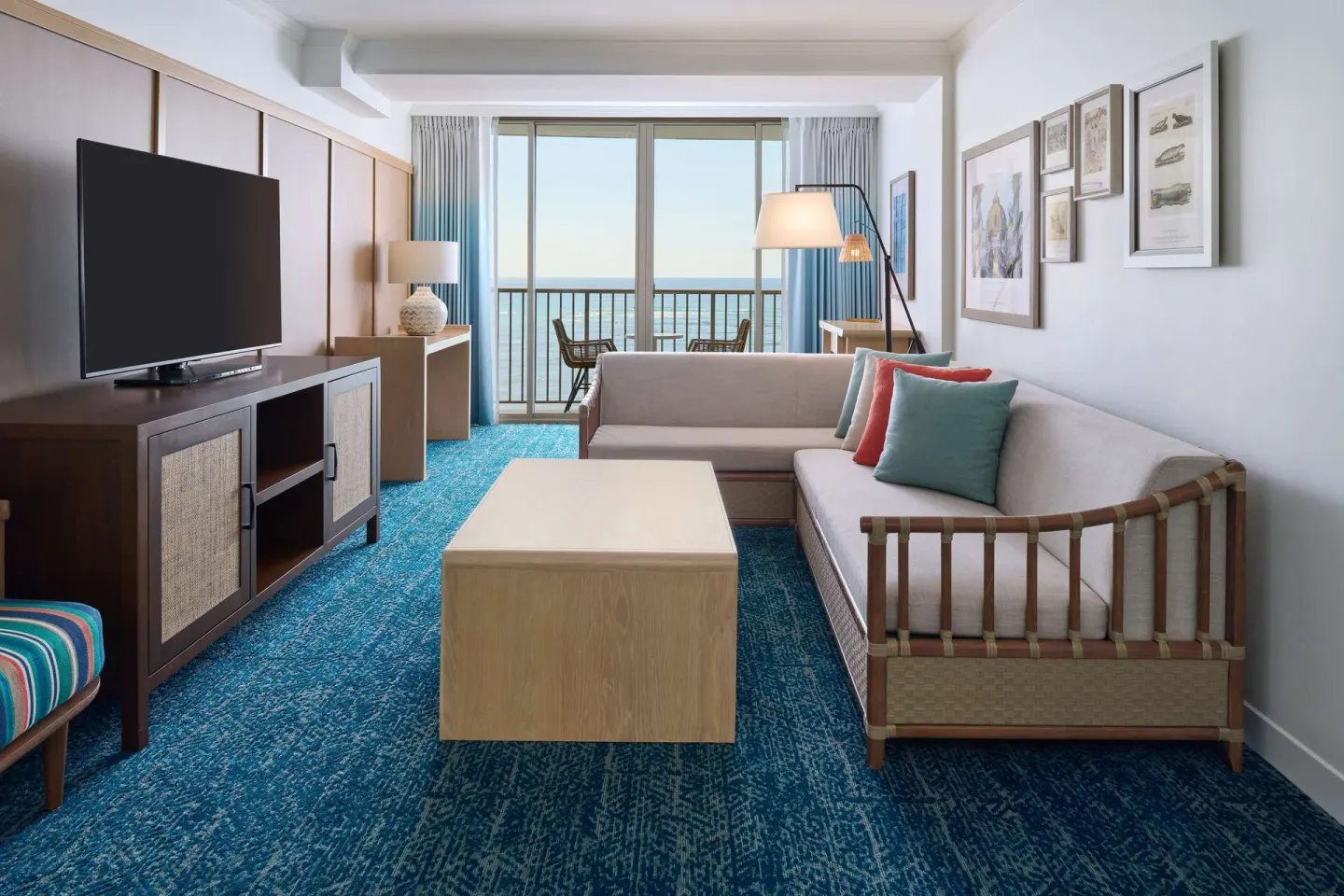 Club Suite living room with sofa bed and ocean balcony at OUTRIGGER Reef Waikiki Beach Resort.