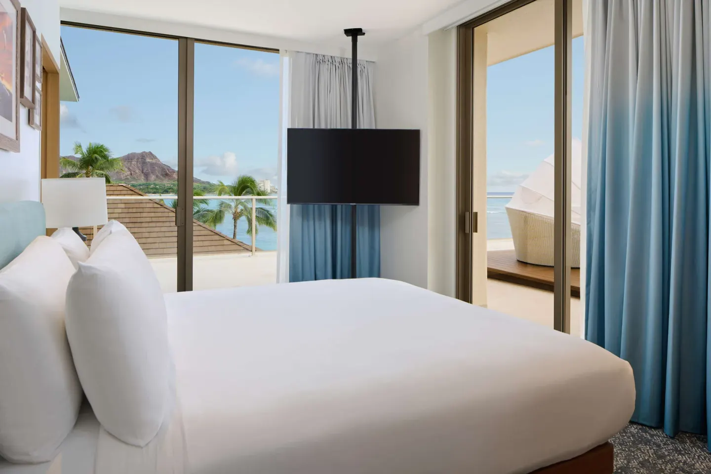 Coral Reef Penthouse Suite bedroom with ocean-facing windows at OUTRIGGER Reef Waikiki Beach Resort.