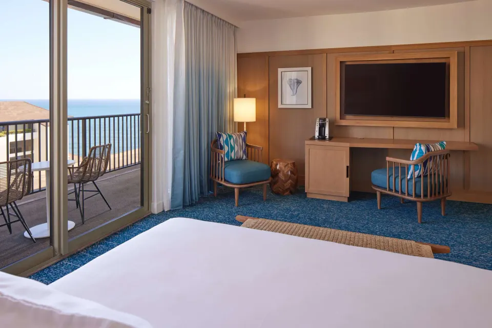 Grand Navigator Suite bedroom with ocean-view balcony at OUTRIGGER Reef Waikiki Beach Resort.