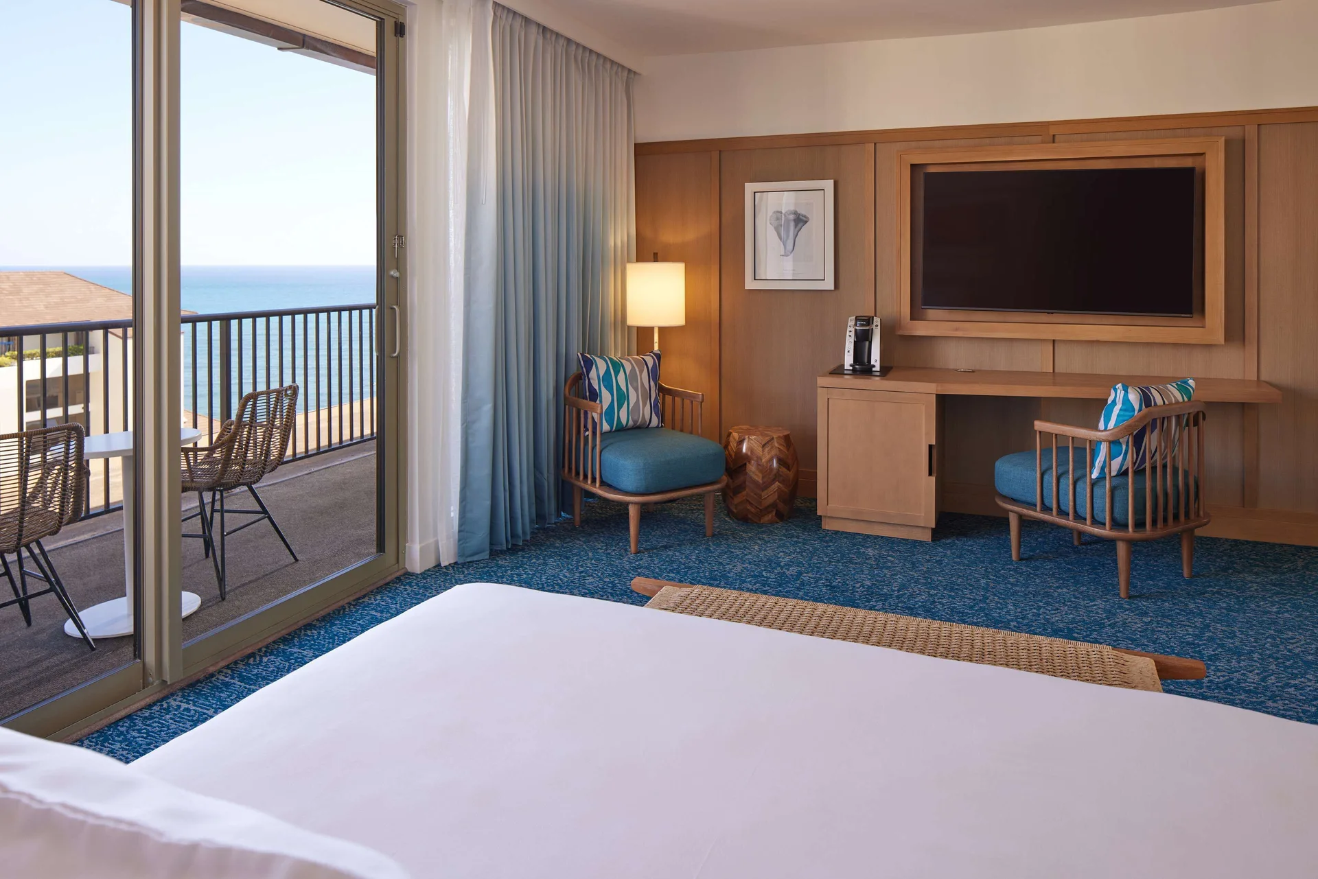Grand Navigator Suite bedroom with ocean-view balcony at OUTRIGGER Reef Waikiki Beach Resort.