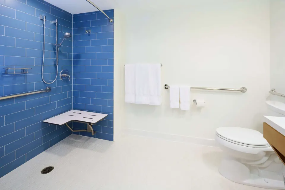 Accessible bathroom with roll-in shower at OUTRIGGER Reef Waikiki Beach Resort.