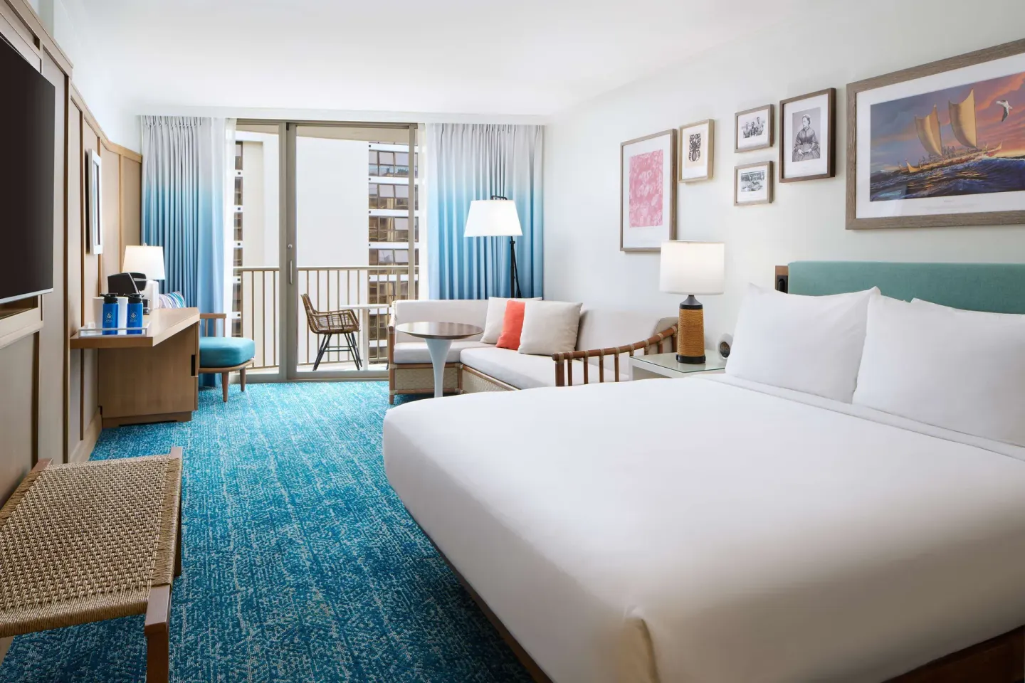 King bed and sofa in a Partial Ocean View room at OUTRIGGER Reef Waikiki Beach Resort.