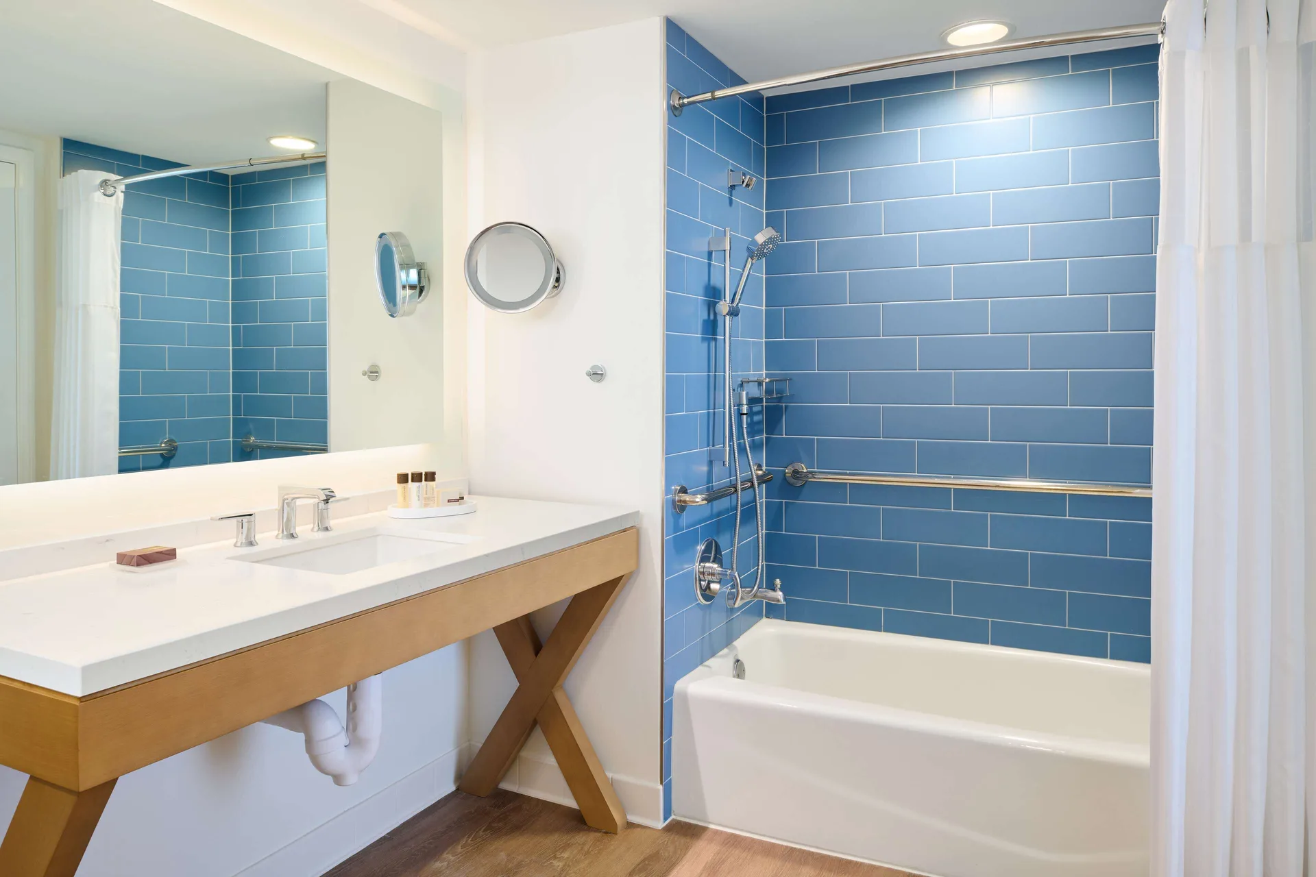 Guest room bathroom with blue tile tub shower at OUTRIGGER Reef Waikiki Beach Resort.