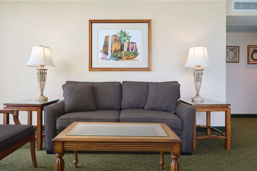 Guest room sitting area with sofa and coffee table at Outrigger Waikiki Beach Resort.