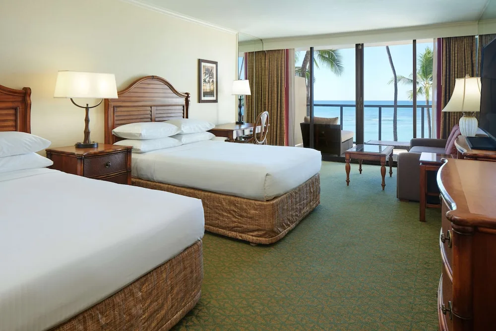 Two-bed oceanfront guest room with sitting area at Outrigger Waikiki Beach Resort.