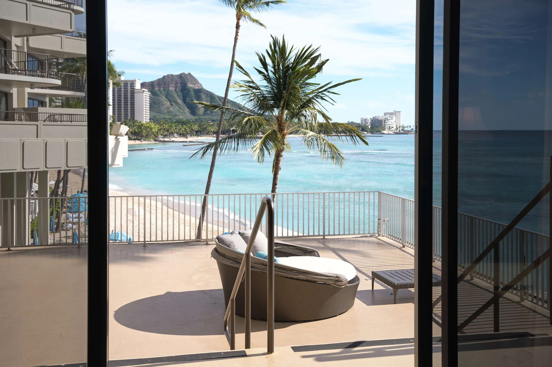 Oceanfront terrace with lounge seating and Waikiki view at Outrigger Waikiki Beach Resort.