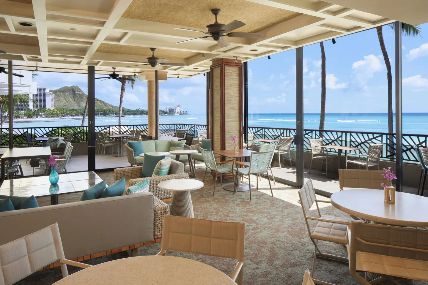 Open-air oceanfront seating area at Outrigger Waikiki Beach Resort.