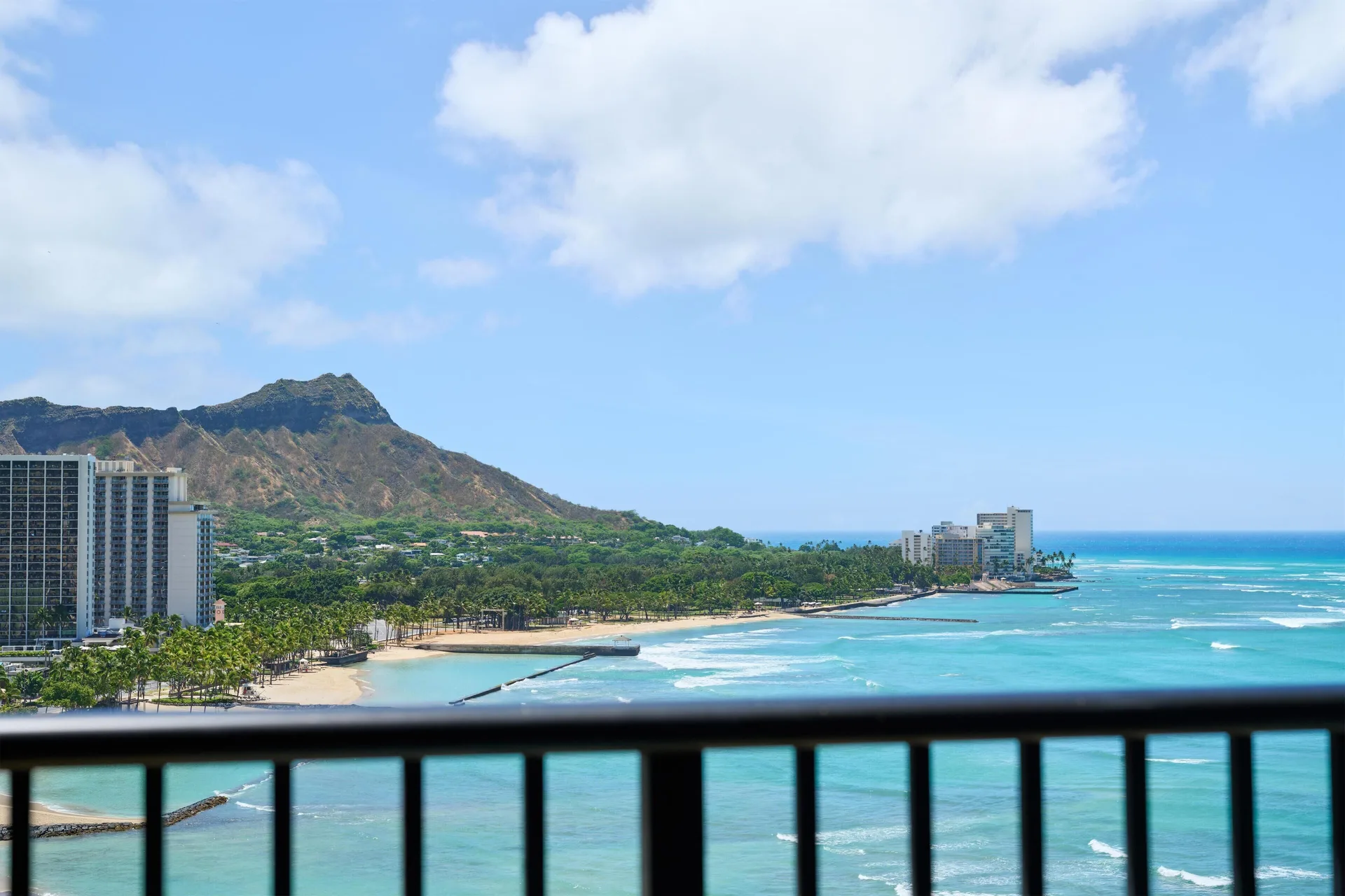 Oceanfront balcony view from Outrigger Waikiki Beach Resort showing Diamond Head and Waikiki shoreline.