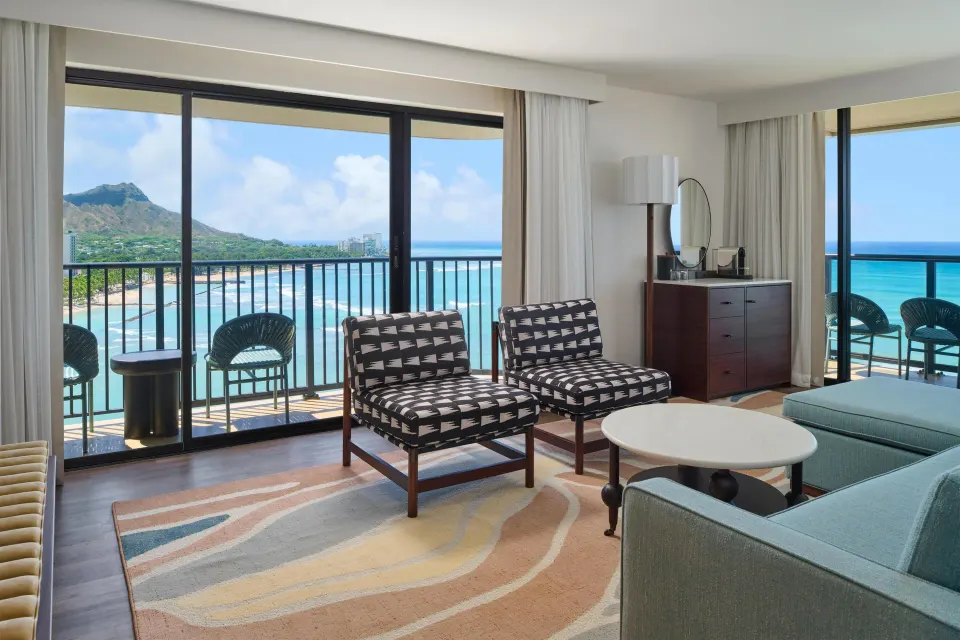 Oceanfront living room in a Club Room 2 Bedrooms at Outrigger Waikiki Beach Resort with balcony views.