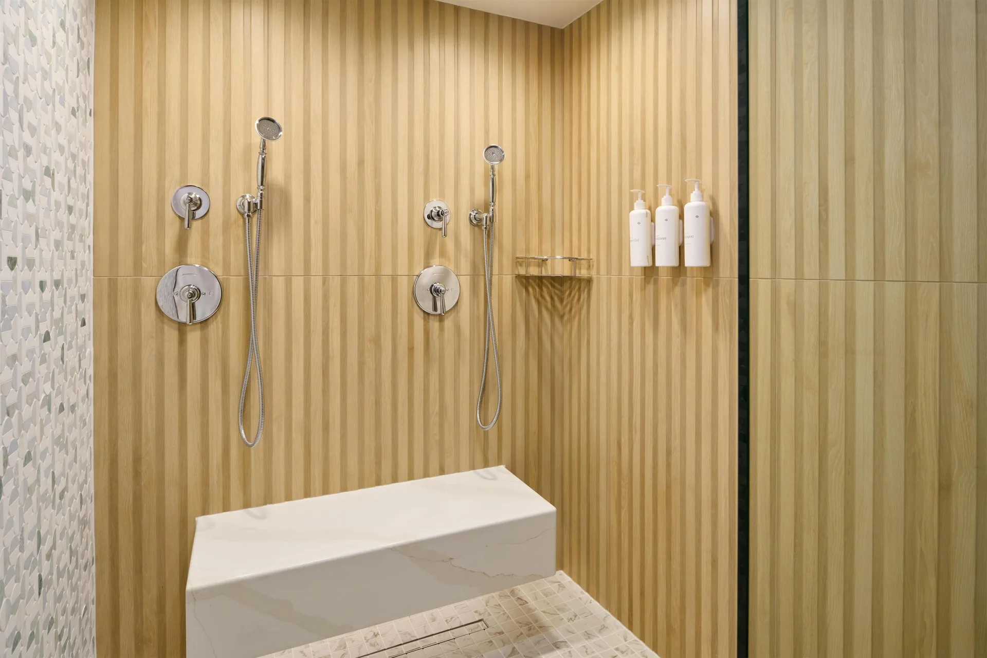 Walk-in shower in a Club Room 2 Bedrooms Oceanfront at Outrigger Waikiki Beach Resort with dual fixtures.