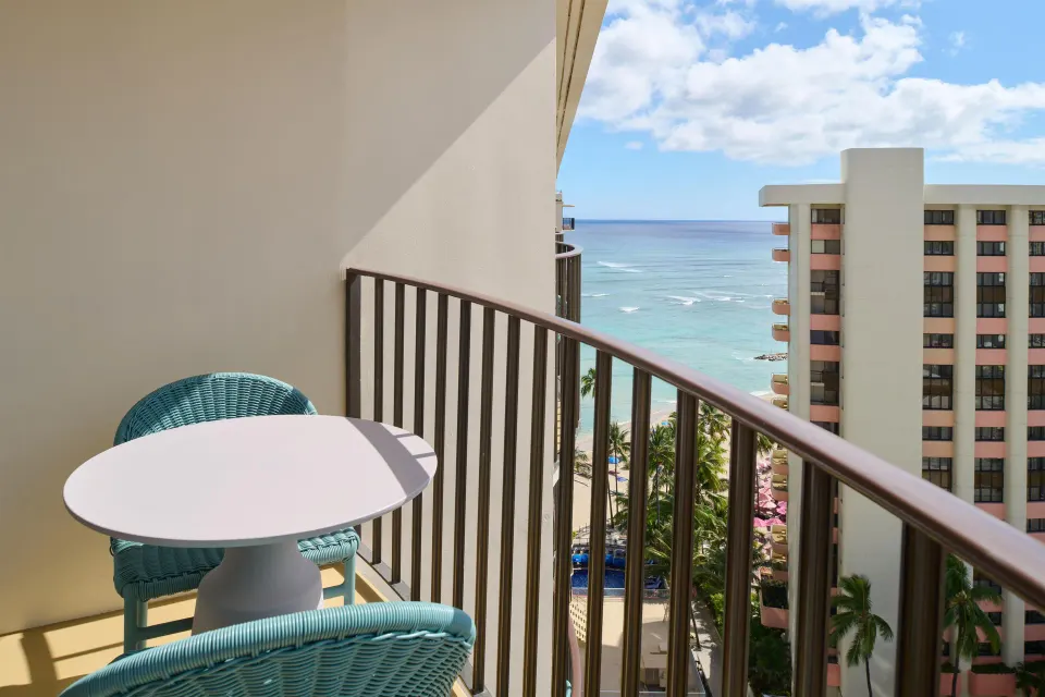 Club Room City View balcony with seating and ocean glimpse at Outrigger Waikiki Beach Resort.