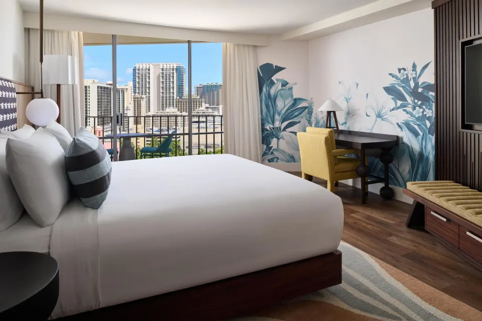 Club Room with king bed and city-view balcony at Outrigger Waikiki Beach Resort.