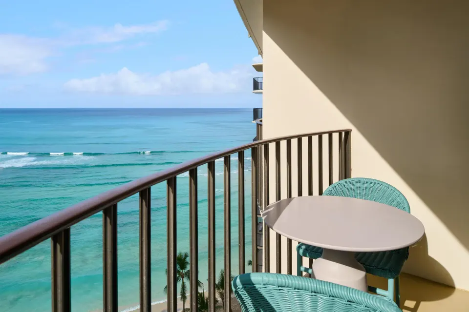 Club Room ocean-view balcony with chairs at Outrigger Waikiki Beach Resort.