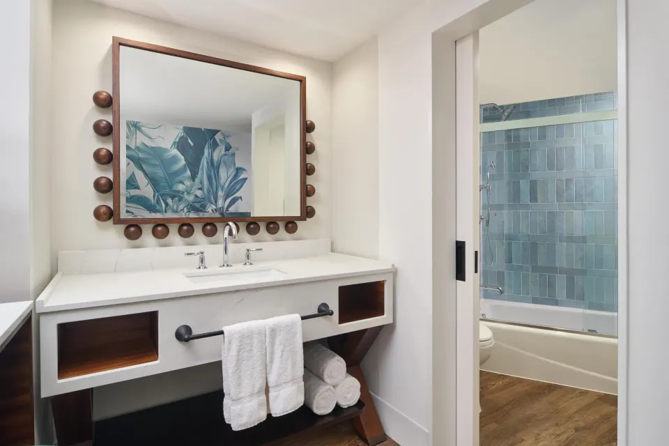 Club Room Oceanfront bathroom vanity and tub shower at Outrigger Waikiki Beach Resort.