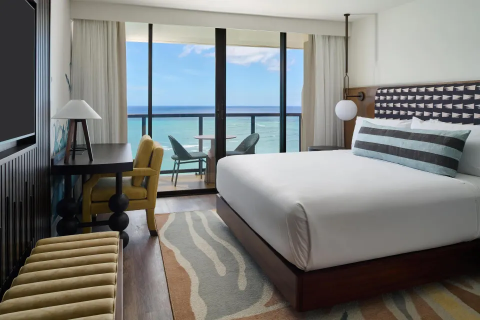 Oceanfront club room with king bed and balcony view at Outrigger Waikiki Beach Resort.