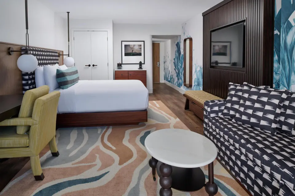 Club Room Oceanfront king bed seating area and entry at Outrigger Waikiki Beach Resort.