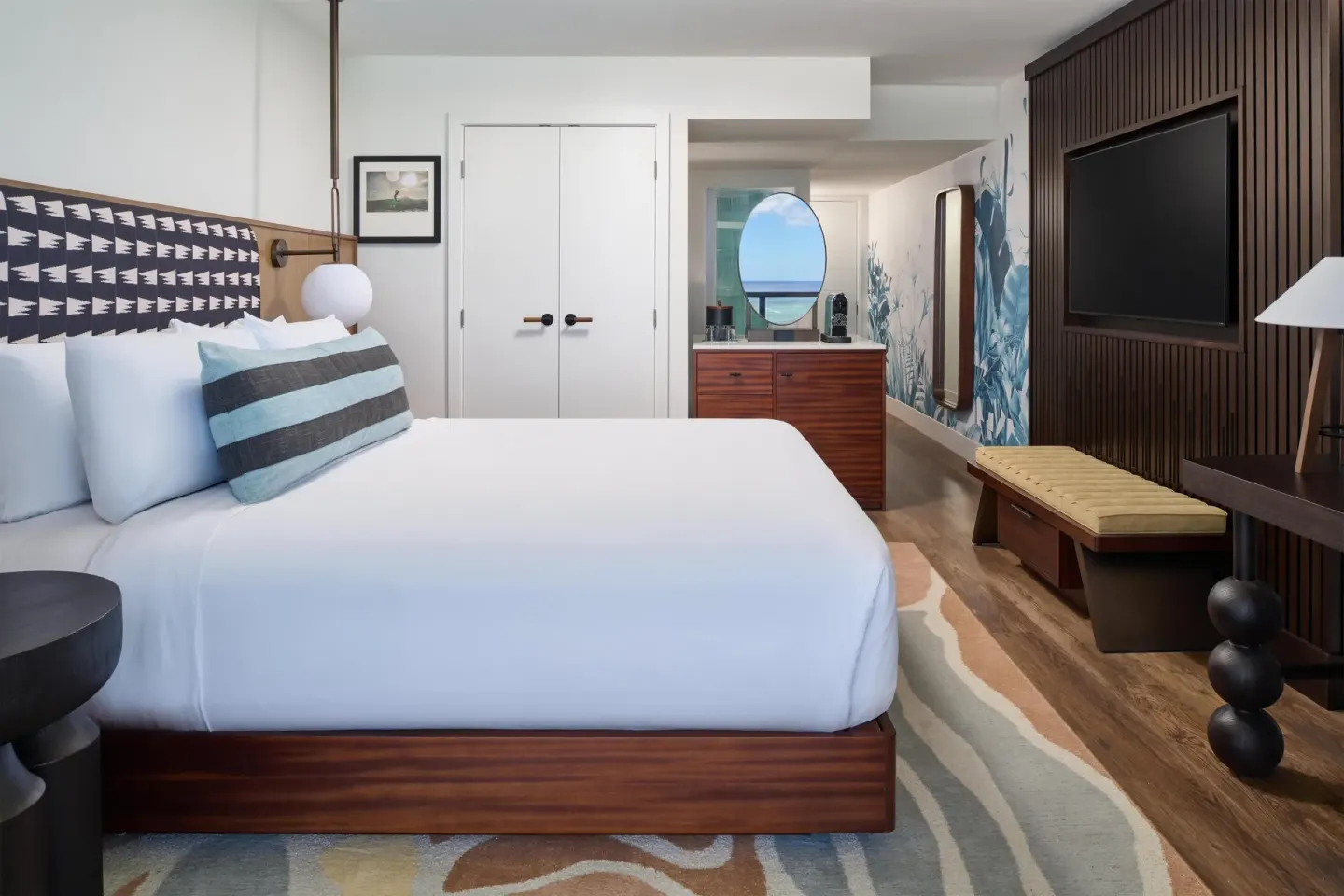 Club Room Oceanfront king bed with dresser and wall-mounted TV at Outrigger Waikiki Beach Resort.