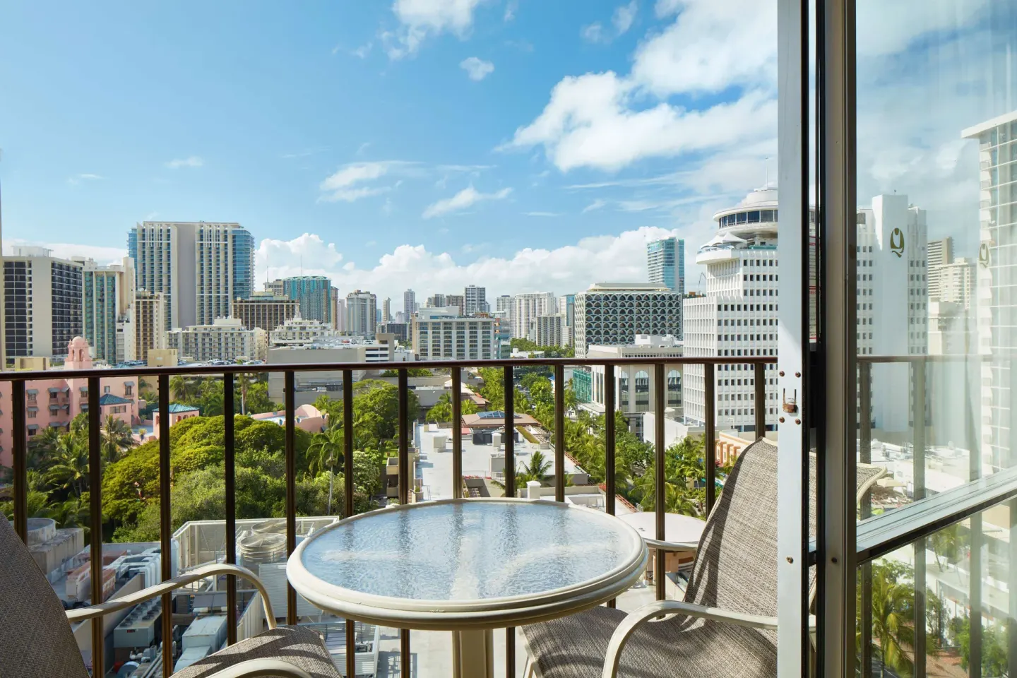 City view balcony with table and chairs at Outrigger Waikiki Beach Resort.