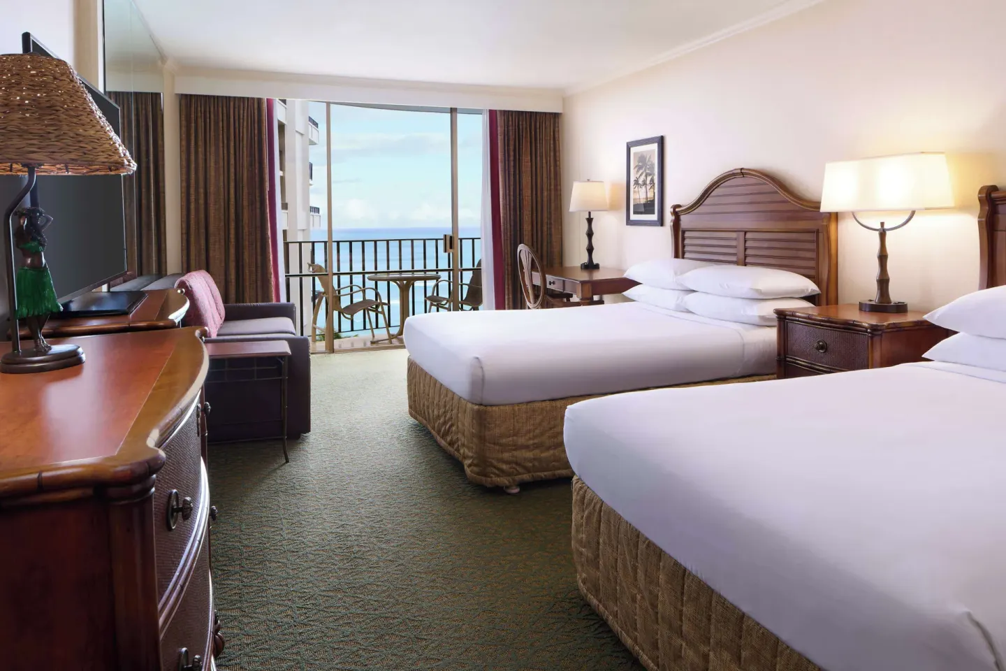 Two-bed ocean view guest room at Outrigger Waikiki Beach Resort with balcony seating.