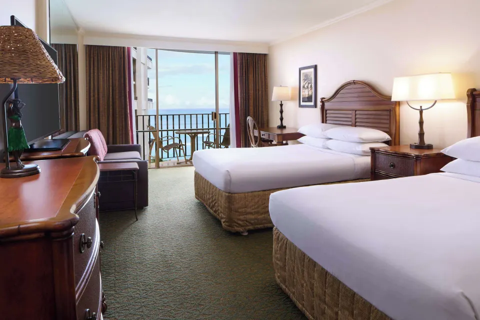 Two-bed ocean view guest room at Outrigger Waikiki Beach Resort with balcony seating.