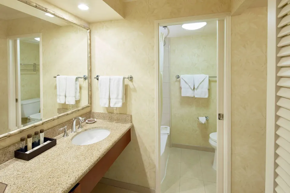 Guest bathroom vanity and tub area at Outrigger Waikiki Beach Resort.