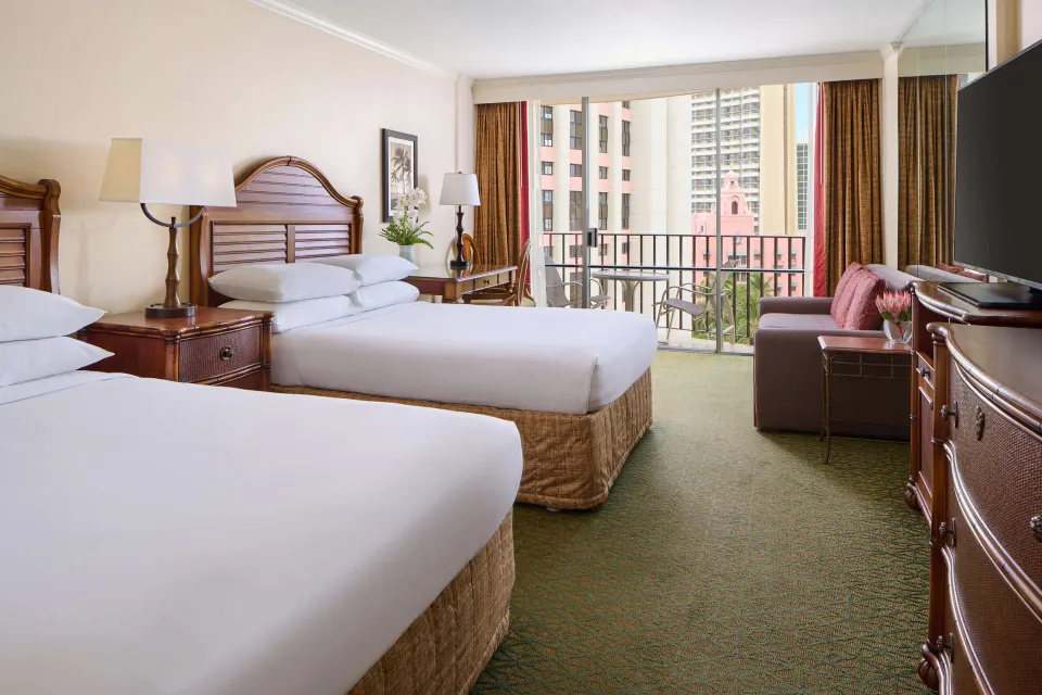 Two-bed room with sofa and balcony at Outrigger Waikiki Beach Resort.