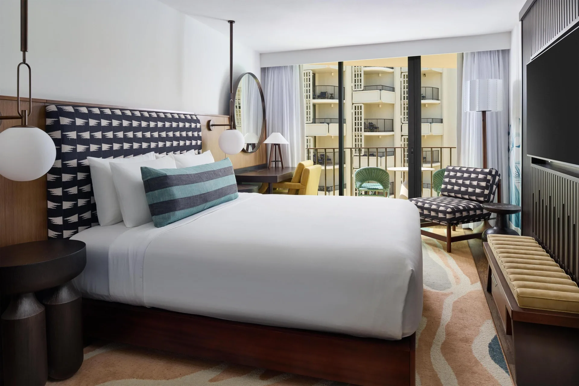 Partial Ocean View king room with balcony seating at Outrigger Waikiki Beach Resort.