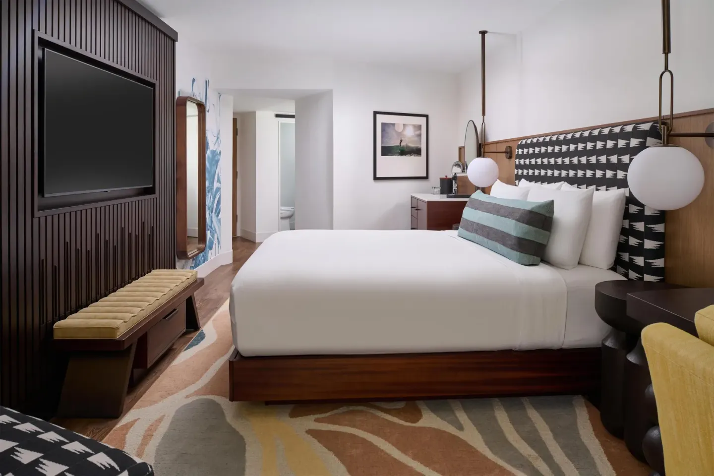 Partial Ocean View king room with wall-mounted TV at Outrigger Waikiki Beach Resort.
