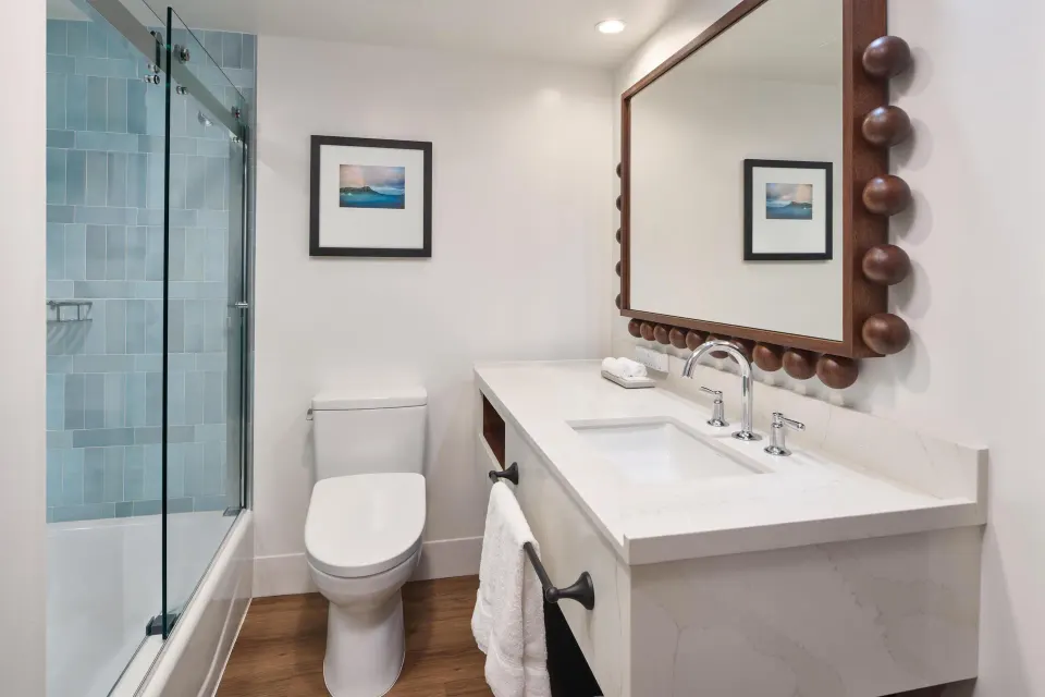 Suite bathroom with glass shower and vanity at Outrigger Waikiki Beach Resort.