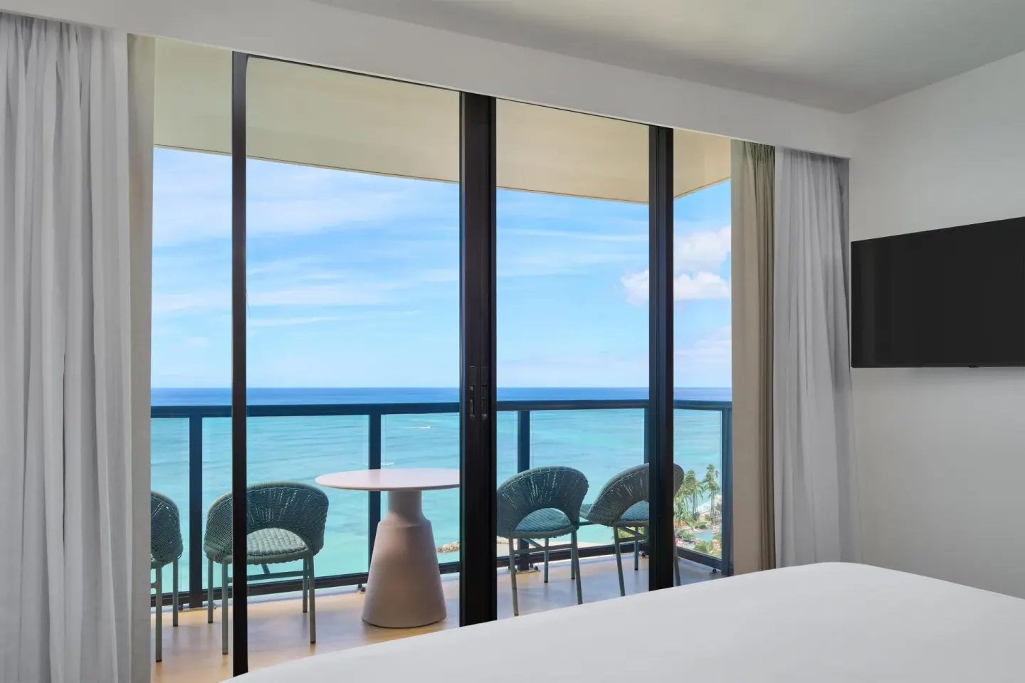 Suite bedroom balcony with ocean view at Outrigger Waikiki Beach Resort.