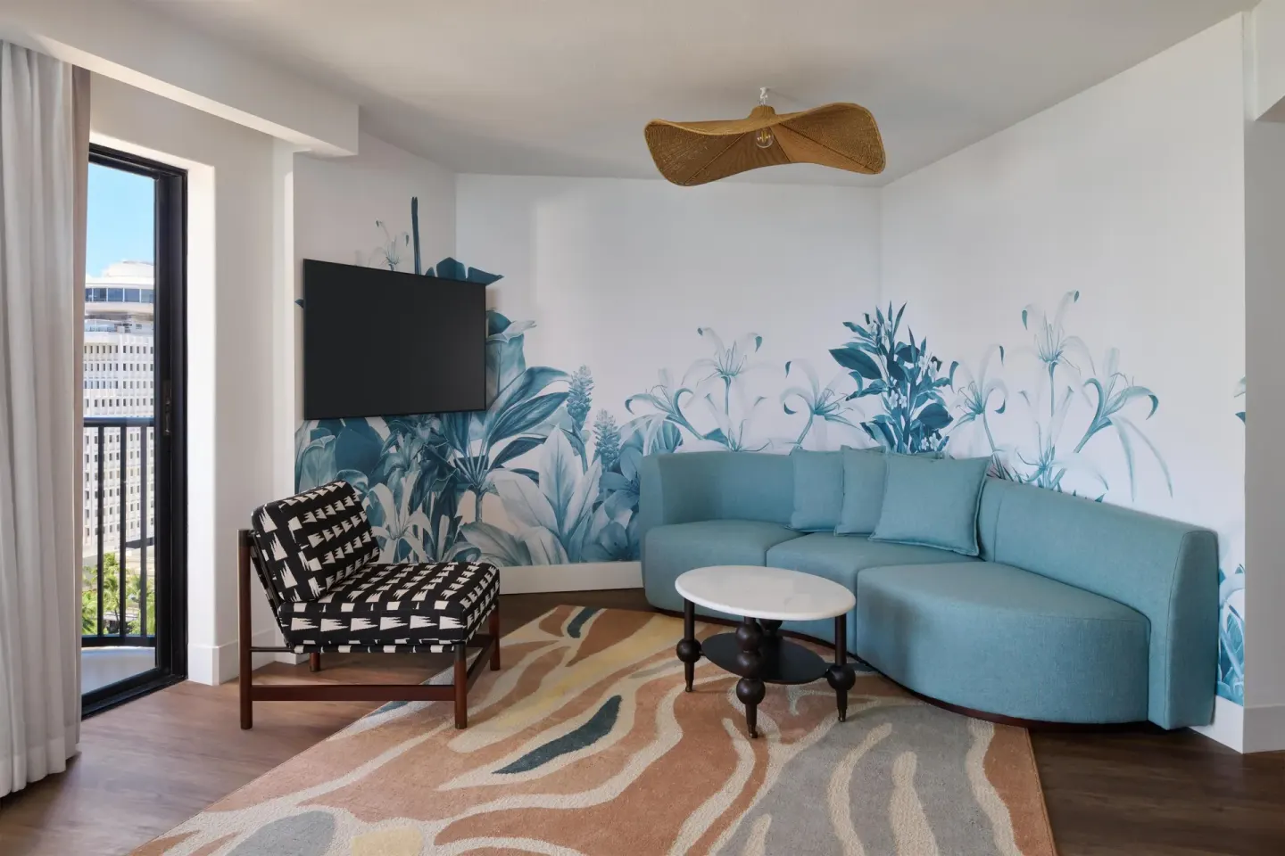 Suite sitting area with blue sofa bed at Outrigger Waikiki Beach Resort.