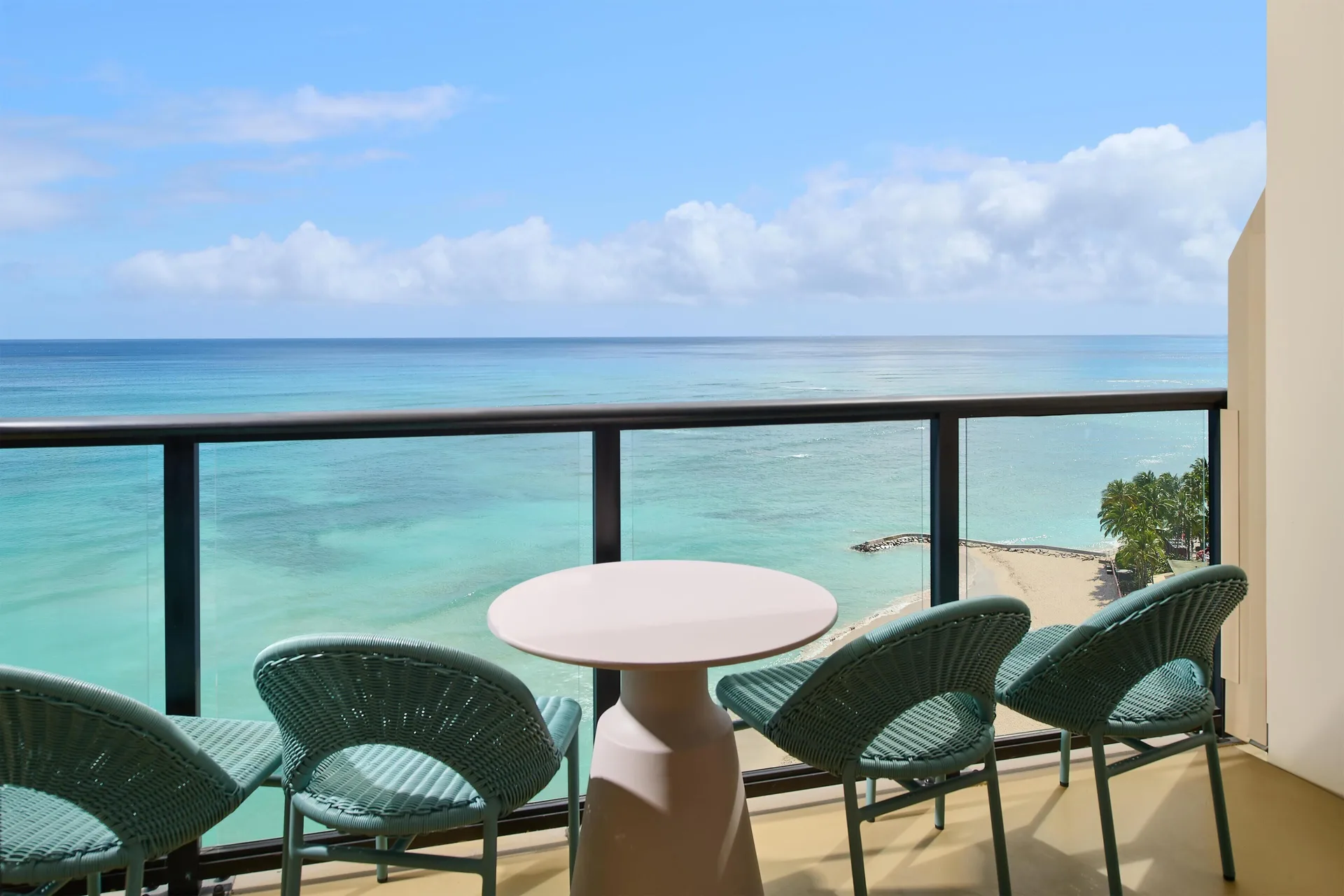 Suite balcony seating with ocean view at Outrigger Waikiki Beach Resort.