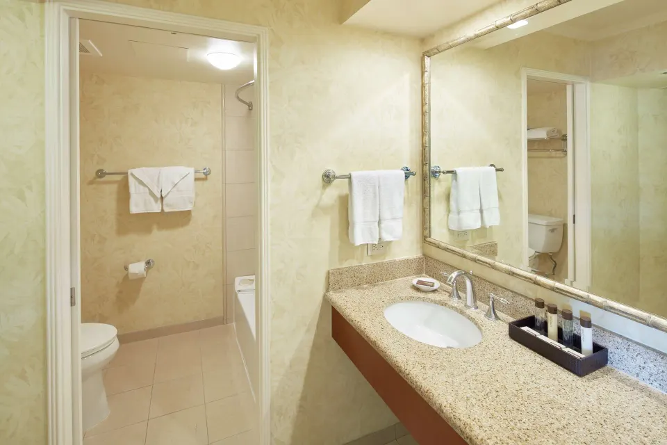 Suite bathroom vanity and shower area at Outrigger Waikiki Beach Resort.
