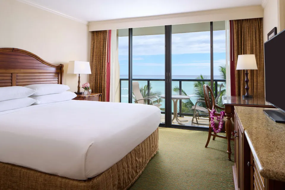King bed suite with balcony ocean view at Outrigger Waikiki Beach Resort.