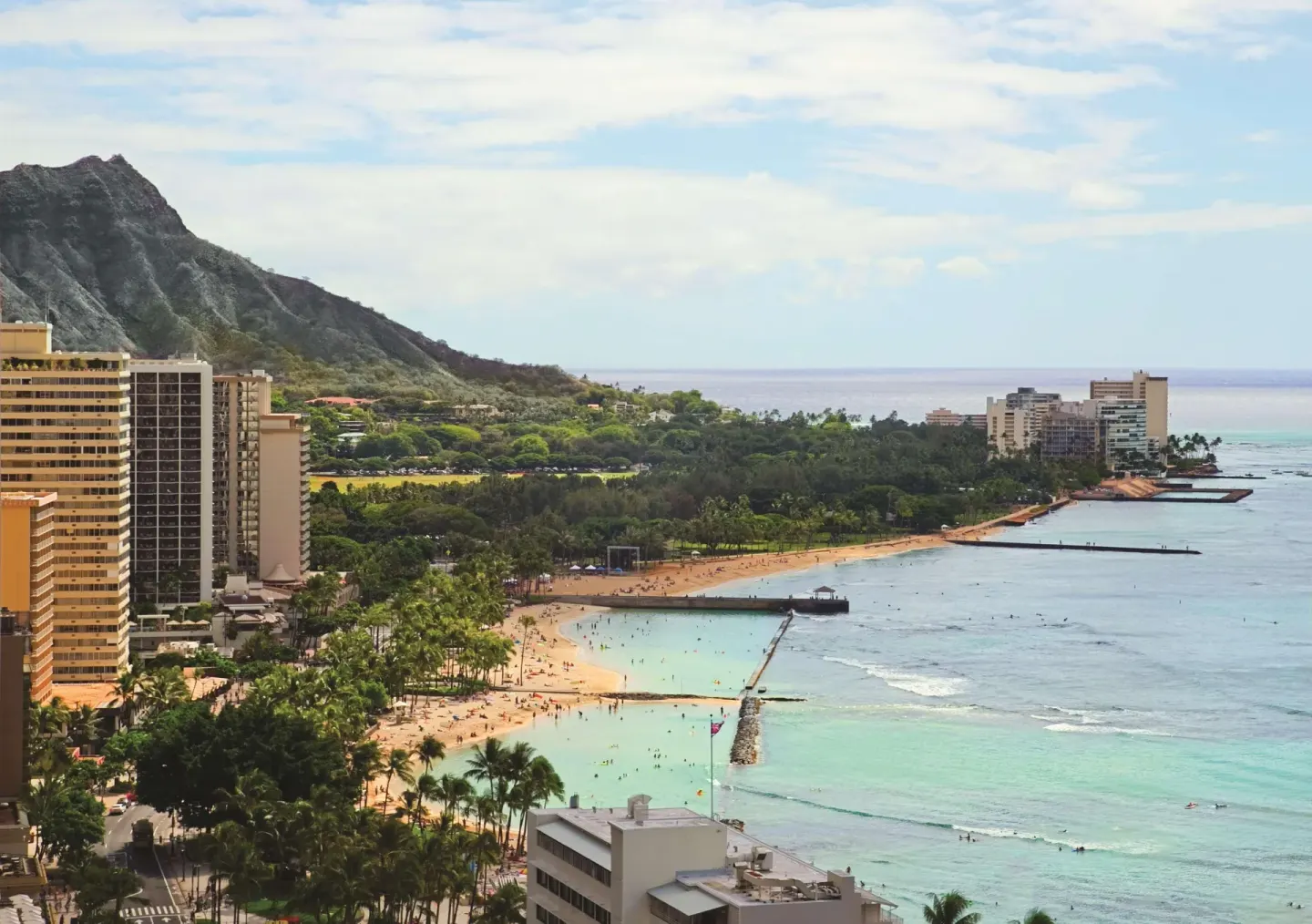 Elevated view of Diamond Head, Waikiki Beach, and calm blue water at OUTRIGGER Waikiki Beachcomber Hotel.