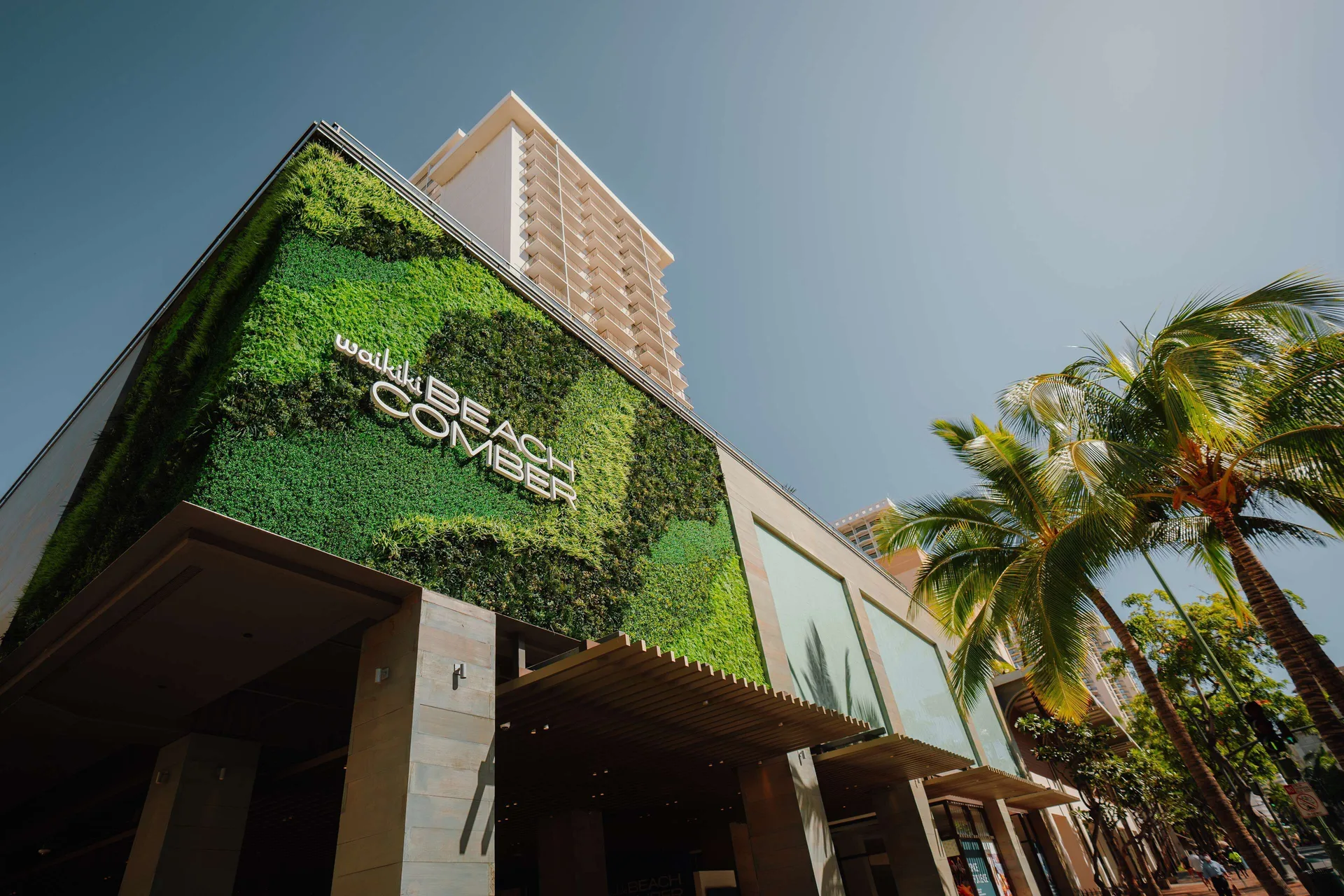 Low-angle view of the green facade at OUTRIGGER Waikiki Beachcomber Hotel.