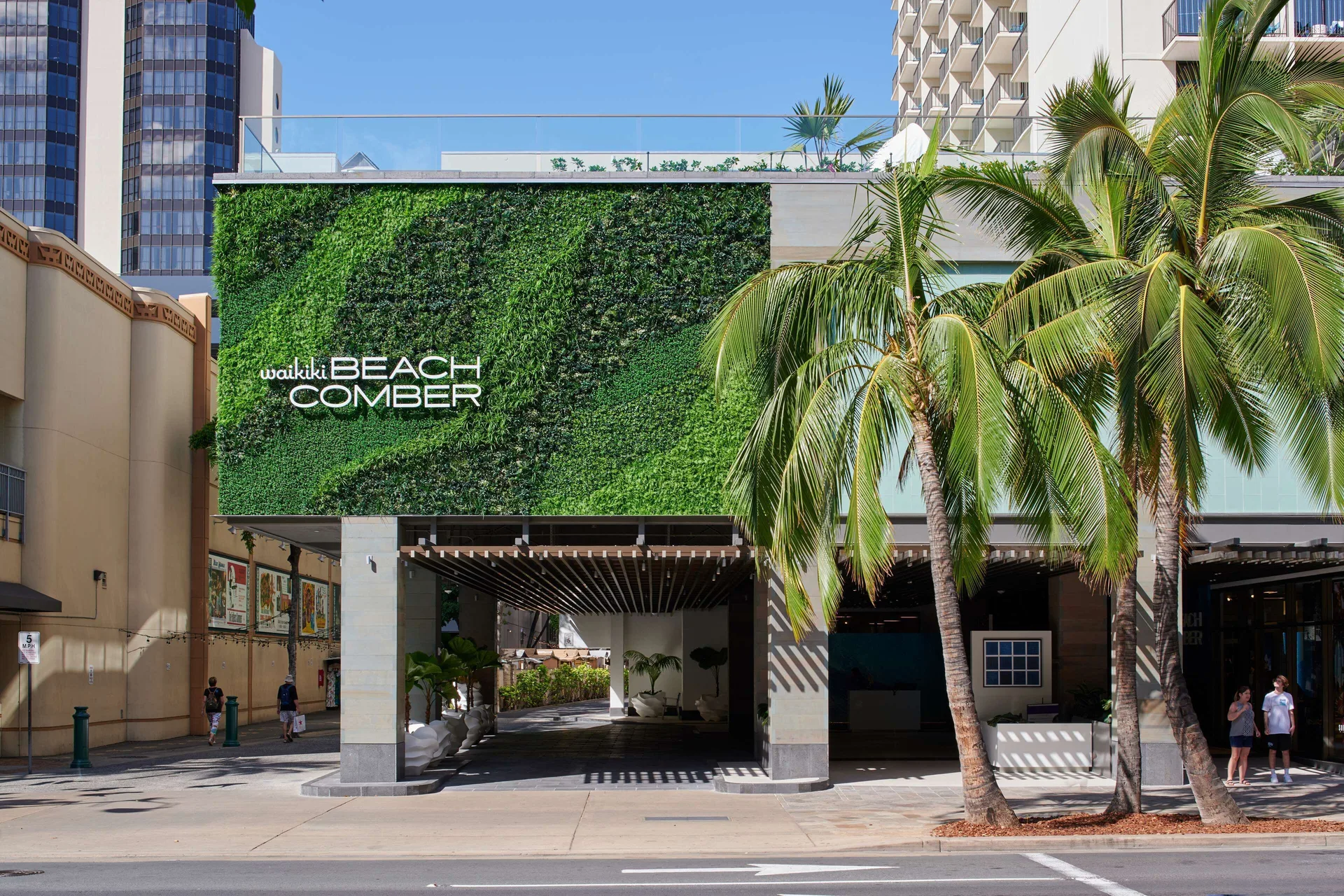 Street entrance with green wall and palms at OUTRIGGER Waikiki Beachcomber Hotel.