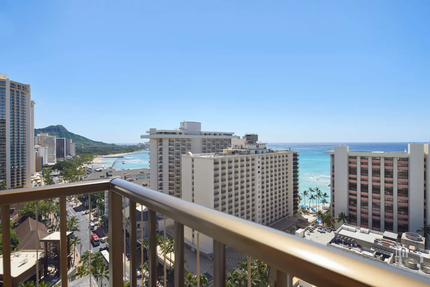Wide balcony view of Waikiki towers, ocean, and Diamond Head at OUTRIGGER Waikiki Beachcomber Hotel.
