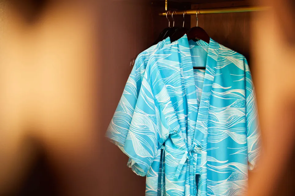 Turquoise patterned robes hang in a Junior Suite closet at OUTRIGGER Waikiki Beachcomber Hotel.