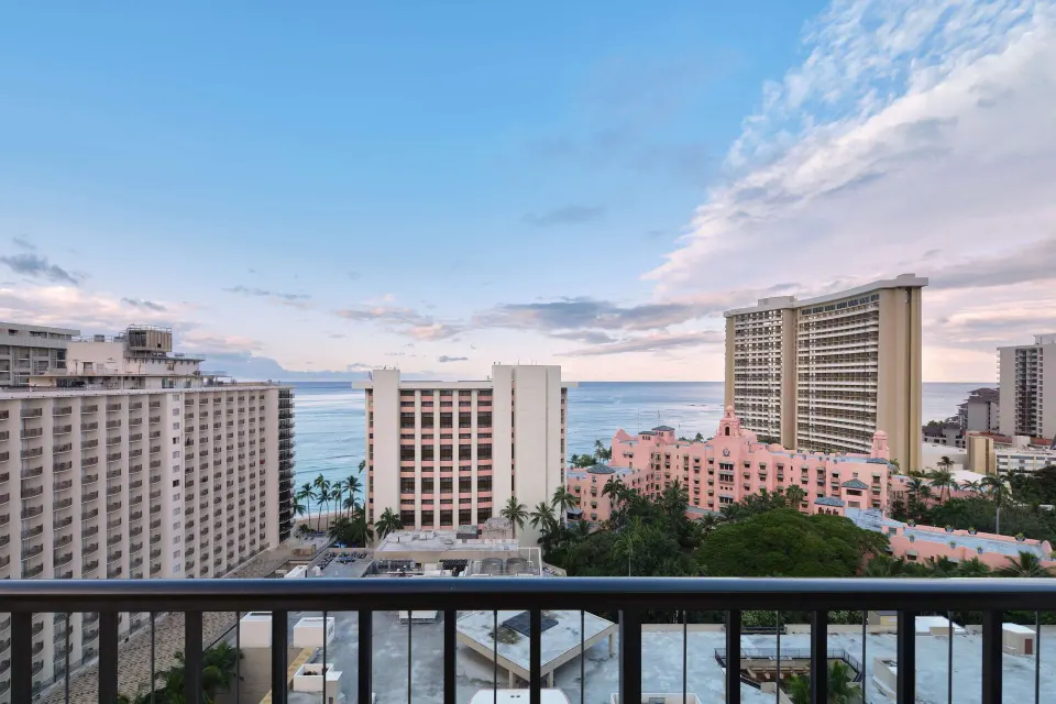 Balcony view of Waikiki buildings, palms and ocean from OUTRIGGER Waikiki Beachcomber Hotel.