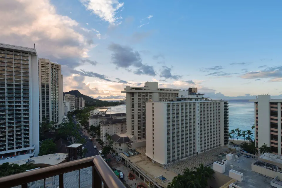 Balcony view over Waikiki buildings toward ocean and Diamond Head at OUTRIGGER Waikiki Beachcomber Hotel.