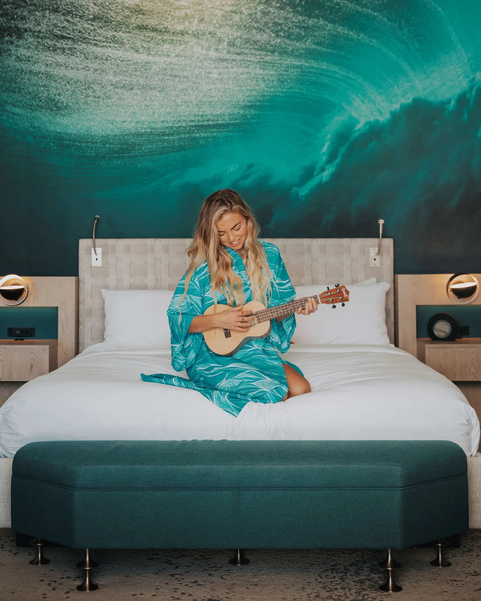 Guest room king bed with ukulele player at OUTRIGGER Waikiki Beachcomber Hotel.