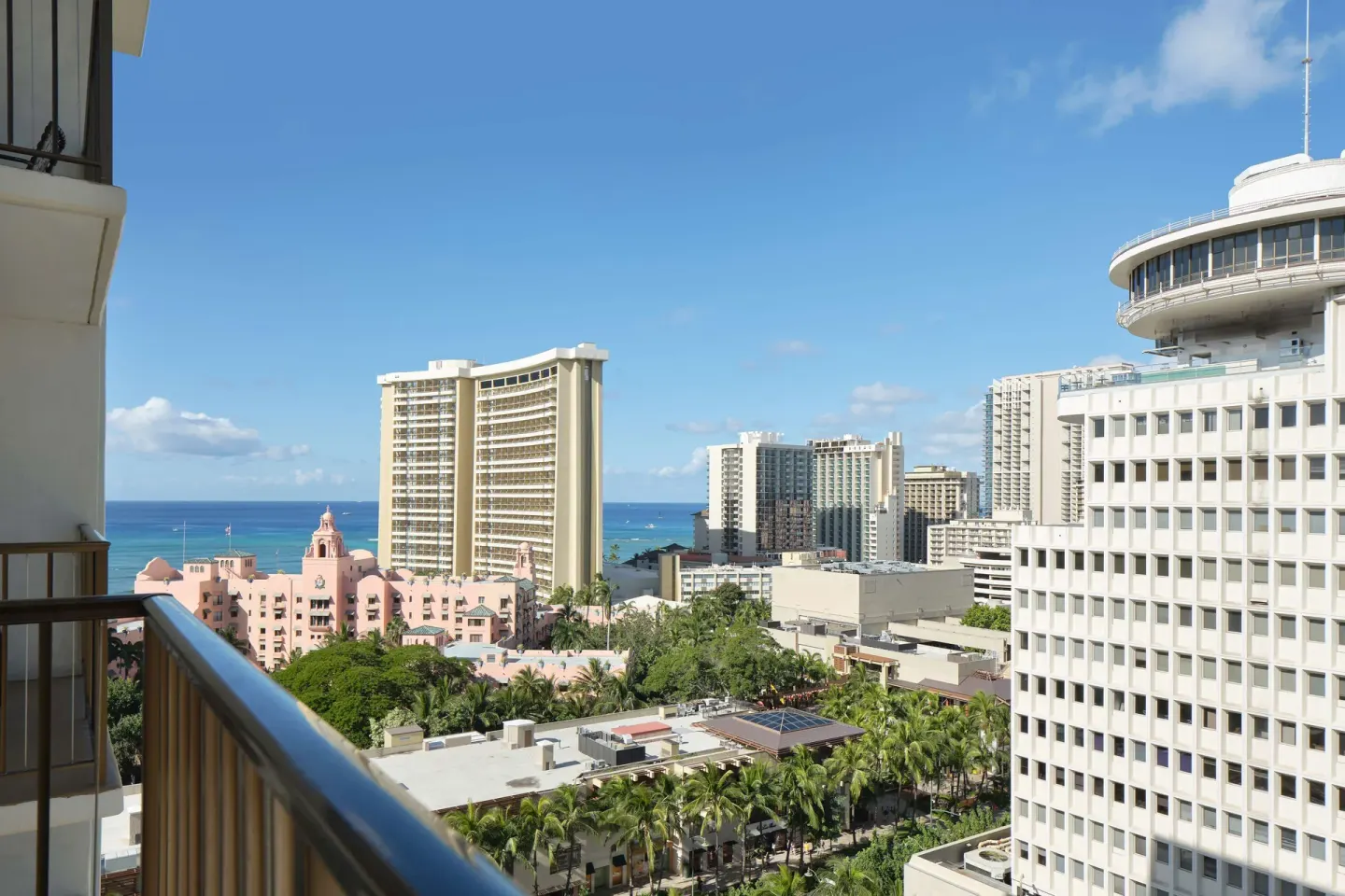 Balcony rail with partial ocean and city view at OUTRIGGER Waikiki Beachcomber Hotel.