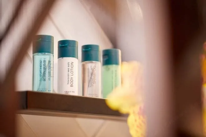 Bathroom toiletries on a shelf in a Partial Ocean View room at Outrigger Waikiki Beachcomber Hotel.