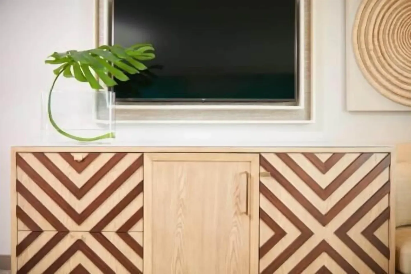 TV and patterned cabinet in a Partial Ocean View room at Outrigger Waikiki Beachcomber Hotel.