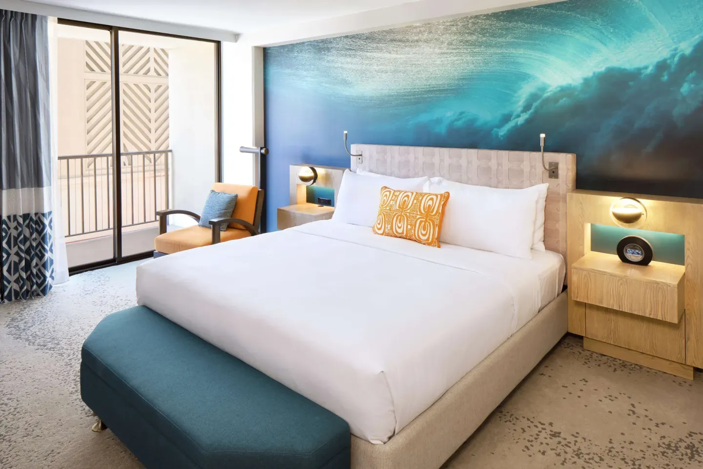 King bed guest room with balcony doors at OUTRIGGER Waikiki Beachcomber Hotel.
