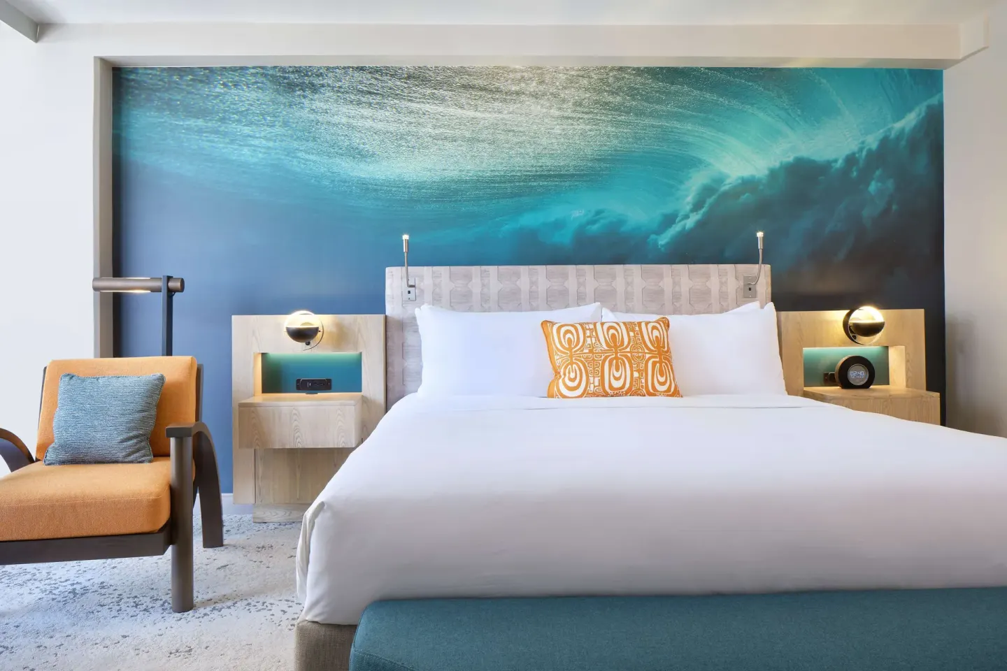 King bed and lounge chair in a guest room at OUTRIGGER Waikiki Beachcomber Hotel.