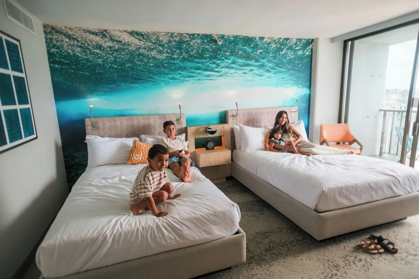 Two queen beds and balcony doors in a Waikiki View room at OUTRIGGER Waikiki Beachcomber Hotel.