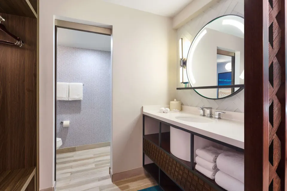 Bathroom vanity and closet in a suite at OUTRIGGER Waikiki Beachcomber Hotel.