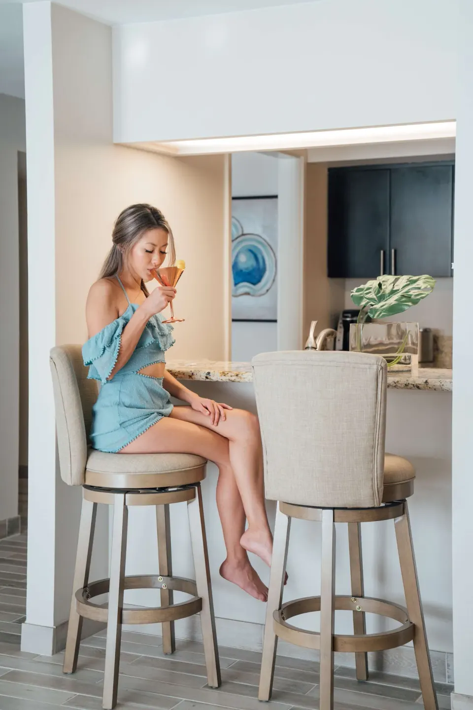 Guest sits at the suite breakfast bar at OUTRIGGER Waikiki Beachcomber Hotel.
